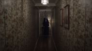 Valak appears in the hallway (Image via YouTube/Warner Bros.)